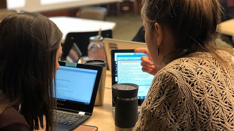 CDS students in class working on open laptops