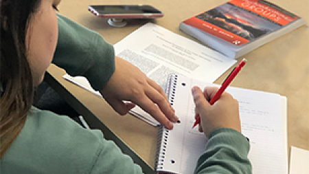 University of Oregon College of Education FHS student at desk writing University of Oregon College of Education FHS student at desk writing