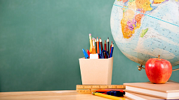 pencil box apple and globe on a desk