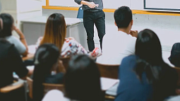 image of individuals facing a person in a classroom setting