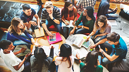 image of students in a group setting sitting down talking