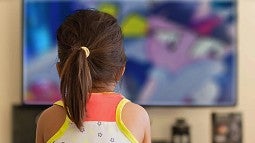 back of a head of a person watching cartoons